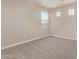Bedroom with neutral carpet and three windows for great natural light at 22863 N 183Rd Dr, Surprise, AZ 85387
