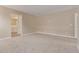 Spacious bedroom featuring neutral walls, plush carpet, and ample natural light with adjoining bathroom at 22863 N 183Rd Dr, Surprise, AZ 85387