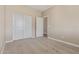 Cozy bedroom with neutral carpeting, a double door closet, and a standard closet door at 22863 N 183Rd Dr, Surprise, AZ 85387