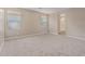 Large bedroom with two windows, neutral carpet and paint with adjoining bathroom and natural light at 22863 N 183Rd Dr, Surprise, AZ 85387
