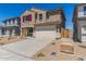 Two-story home with a two-car garage, a long concrete driveway, and a well kept yard at 22863 N 183Rd Dr, Surprise, AZ 85387