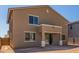 Exterior view of home showing stucco siding, covered patio, and large windows providing natural light at 22863 N 183Rd Dr, Surprise, AZ 85387