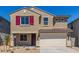 Two-story home with a two-car garage, a well kept yard and an inviting front entrance at 22863 N 183Rd Dr, Surprise, AZ 85387