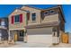 Two-story home with a two-car garage, an inviting front entrance and tan exterior at 22863 N 183Rd Dr, Surprise, AZ 85387