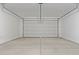 Spacious garage with a large garage door and concrete floor at 22863 N 183Rd Dr, Surprise, AZ 85387