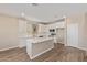 Modern kitchen boasts white cabinets, an island with quartz countertop, and stainless steel appliances at 22863 N 183Rd Dr, Surprise, AZ 85387