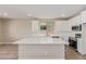 Spacious kitchen island features white quartz countertops and ample room for food preparation and dining at 22863 N 183Rd Dr, Surprise, AZ 85387