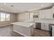 Bright kitchen features a center island, quartz countertop, stainless steel appliances, and natural light at 22863 N 183Rd Dr, Surprise, AZ 85387