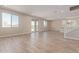 Open-concept living room with hard wood floors, neutral paint, and sliding glass door at 22863 N 183Rd Dr, Surprise, AZ 85387