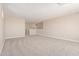 Spacious living room featuring neutral walls, plush carpet, and ample natural light from the adjacent staircase at 22863 N 183Rd Dr, Surprise, AZ 85387