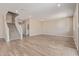 Open-concept living room with hard wood floors, neutral paint, and staircase at 22863 N 183Rd Dr, Surprise, AZ 85387