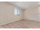 Bright living room featuring wood-look tile flooring and a large window that offers natural light at 22863 N 183Rd Dr, Surprise, AZ 85387