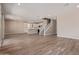 Open-concept living room with hard wood floors, neutral paint, and kitchen view at 22863 N 183Rd Dr, Surprise, AZ 85387