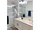 Well-lit bathroom with double sinks, a glass-enclosed shower, and sleek fixtures at 244 N Rock St, Gilbert, AZ 85234