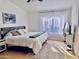 Bright bedroom with a queen bed, neutral decor, and a large window for natural light at 244 N Rock St, Gilbert, AZ 85234