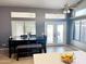 Dining area with a dark wood table, stylish bench, and French doors to the backyard at 244 N Rock St, Gilbert, AZ 85234