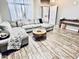 Inviting living room with an oversized sectional sofa and wood-look floors at 244 N Rock St, Gilbert, AZ 85234