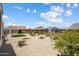 Expansive backyard showcasing desert landscaping, synthetic grass and outdoor space at 26824 W Ponderosa Ln, Buckeye, AZ 85396