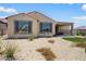 Attractive backyard featuring desert landscaping and a covered patio, perfect for outdoor living at 26824 W Ponderosa Ln, Buckeye, AZ 85396