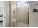 Tiled shower with glass door, built-in seat, and inset shelf at 26824 W Ponderosa Ln, Buckeye, AZ 85396