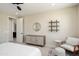 Bright bedroom features stylish furniture, a round mirror, decorative shelving, and a cozy armchair at 26824 W Ponderosa Ln, Buckeye, AZ 85396