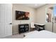 Bedroom with TV, desk, and window offering neighborhood view at 26824 W Ponderosa Ln, Buckeye, AZ 85396
