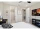 Bedroom with ensuite bathroom, TV, and neutral decor at 26824 W Ponderosa Ln, Buckeye, AZ 85396
