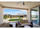 Inviting covered patio with comfortable seating and a view of the landscaped backyard at 26824 W Ponderosa Ln, Buckeye, AZ 85396