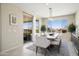 The dining room with a large window and sliding glass door, providing ample natural light and backyard views at 26824 W Ponderosa Ln, Buckeye, AZ 85396