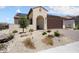 Charming single-story home featuring desert landscaping, a stucco facade, and a tile roof with solar panels at 26824 W Ponderosa Ln, Buckeye, AZ 85396