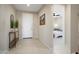Bright foyer featuring tile flooring, a white front door, and a view into the home's bedroom at 26824 W Ponderosa Ln, Buckeye, AZ 85396