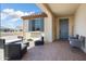 Inviting covered patio featuring stylish outdoor seating and a view of the landscaped surroundings at 26824 W Ponderosa Ln, Buckeye, AZ 85396