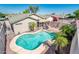 Aerial view of a backyard featuring a uniquely shaped pool, mature palm trees, and a serene outdoor space at 2721 N 107Th Dr, Avondale, AZ 85392