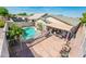 Inviting backyard showcasing a pool with safety fence, covered patio, and a cozy space for relaxation and entertaining at 2721 N 107Th Dr, Avondale, AZ 85392