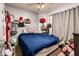 The main bedroom includes dark blue bedding and lots of clutter around the room at 2721 N 107Th Dr, Avondale, AZ 85392