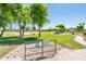 Community park featuring mature shade trees, a playground, and a baseball field in a Gathering-friendly environment at 2721 N 107Th Dr, Avondale, AZ 85392