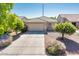 Charming single-story home with a well-maintained front yard, mature landscaping, and a spacious two-car garage at 2721 N 107Th Dr, Avondale, AZ 85392