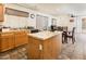 Open concept kitchen with wood cabinets and island that is connected to the dining room at 2721 N 107Th Dr, Avondale, AZ 85392