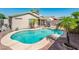 Backyard view with a private pool and palm trees, perfect for relaxation and outdoor enjoyment at 2721 N 107Th Dr, Avondale, AZ 85392