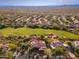 Aerial view of desert home that backs up to a golf course in a scenic mountain community at 28768 N 95Th Way, Scottsdale, AZ 85262