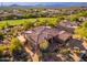 An aerial view of a beautiful home with desert landscaping near a golf course at 28768 N 95Th Way, Scottsdale, AZ 85262
