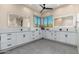Bright bathroom features light stone floors, dual vanity sinks, lighted mirrors and picture window at 28768 N 95Th Way, Scottsdale, AZ 85262