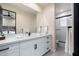 Elegant bathroom featuring double sinks, quartz countertop, modern fixtures and a shower with custom tile work at 28768 N 95Th Way, Scottsdale, AZ 85262