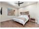 Bright bedroom features hardwood floors, modern ceiling fan, and ample natural light from a large window at 28768 N 95Th Way, Scottsdale, AZ 85262