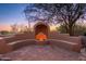 Outdoor fireplace and seating area offer a cozy retreat with a warm ambiance and desert views at 28768 N 95Th Way, Scottsdale, AZ 85262