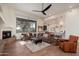 Spacious living room featuring a fireplace, oversized couch, and open floor plan at 28768 N 95Th Way, Scottsdale, AZ 85262