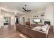 Open concept living room featuring a fireplace, a large TV and comfortable seating at 28768 N 95Th Way, Scottsdale, AZ 85262