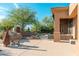 Spacious patio area with outdoor grill, chiminea, dining furniture, and desert landscaping at 28768 N 95Th Way, Scottsdale, AZ 85262