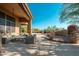 The large patio has comfortable seating, a grill and outdoor fireplace for entertaining at 28768 N 95Th Way, Scottsdale, AZ 85262