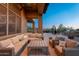 Inviting outdoor space with comfortable seating, a coffee table, and beautiful twilight scenery at 28768 N 95Th Way, Scottsdale, AZ 85262
